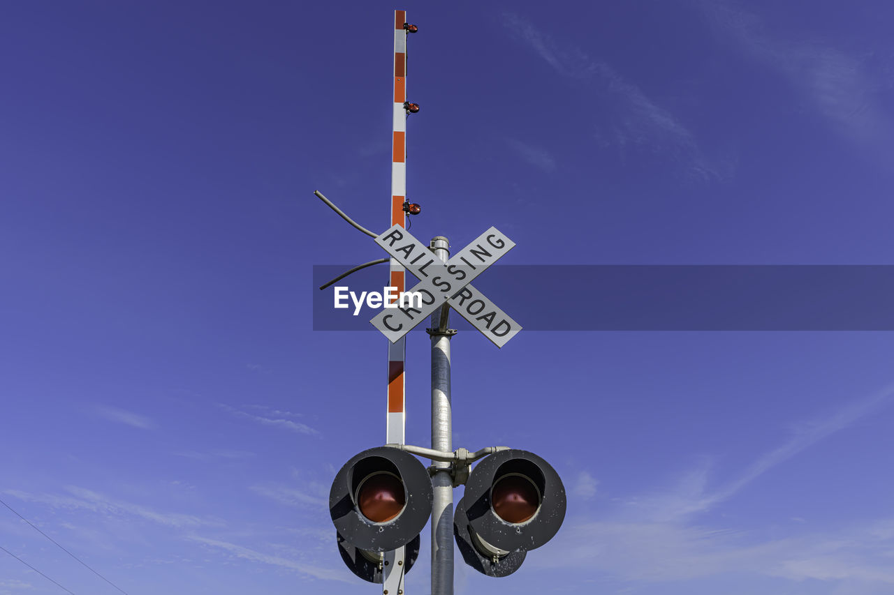 Low angle view of information sign against sky