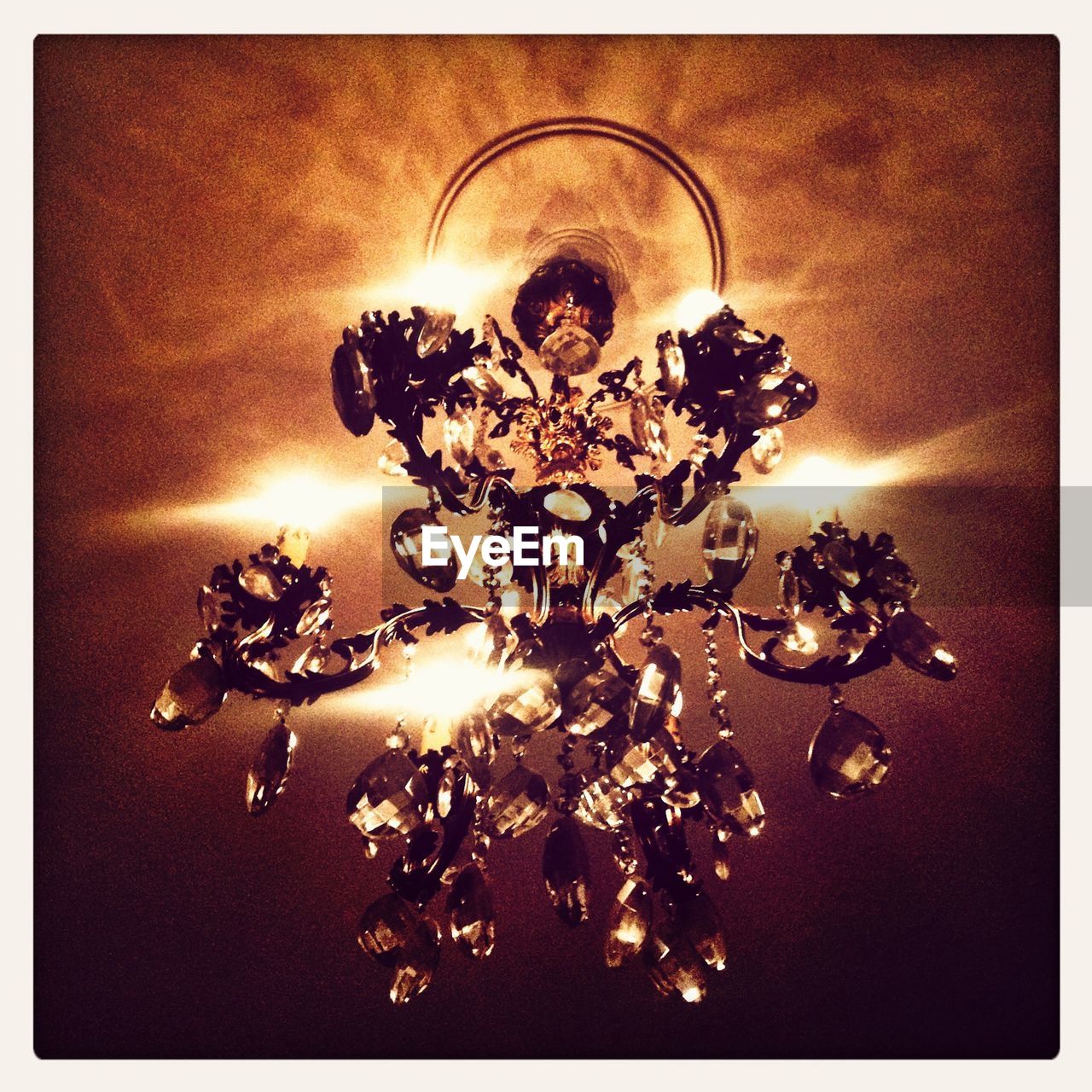 Illuminated chandelier hanging on ceiling