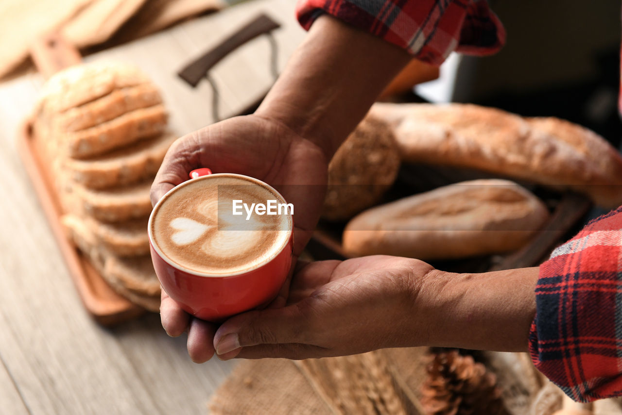 Cropped hands of man holding coffee