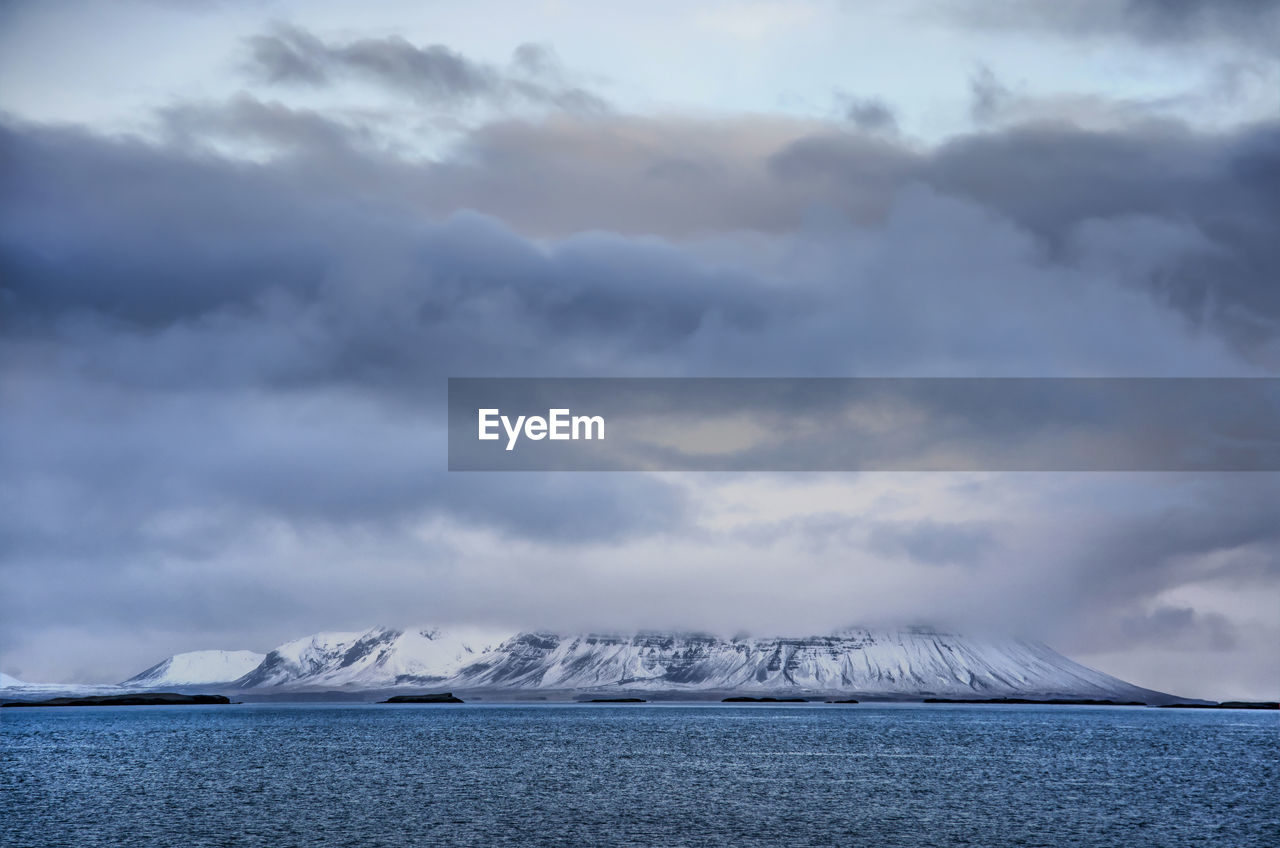 View across breiðafjörður in iceland towards snaefellsnes peninsula with snow-covered mountains 