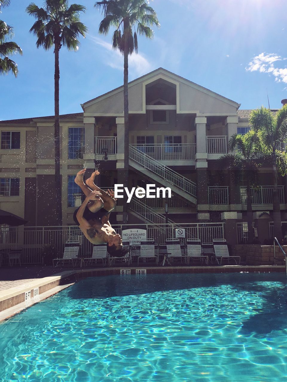 Man jumping in swimming pool