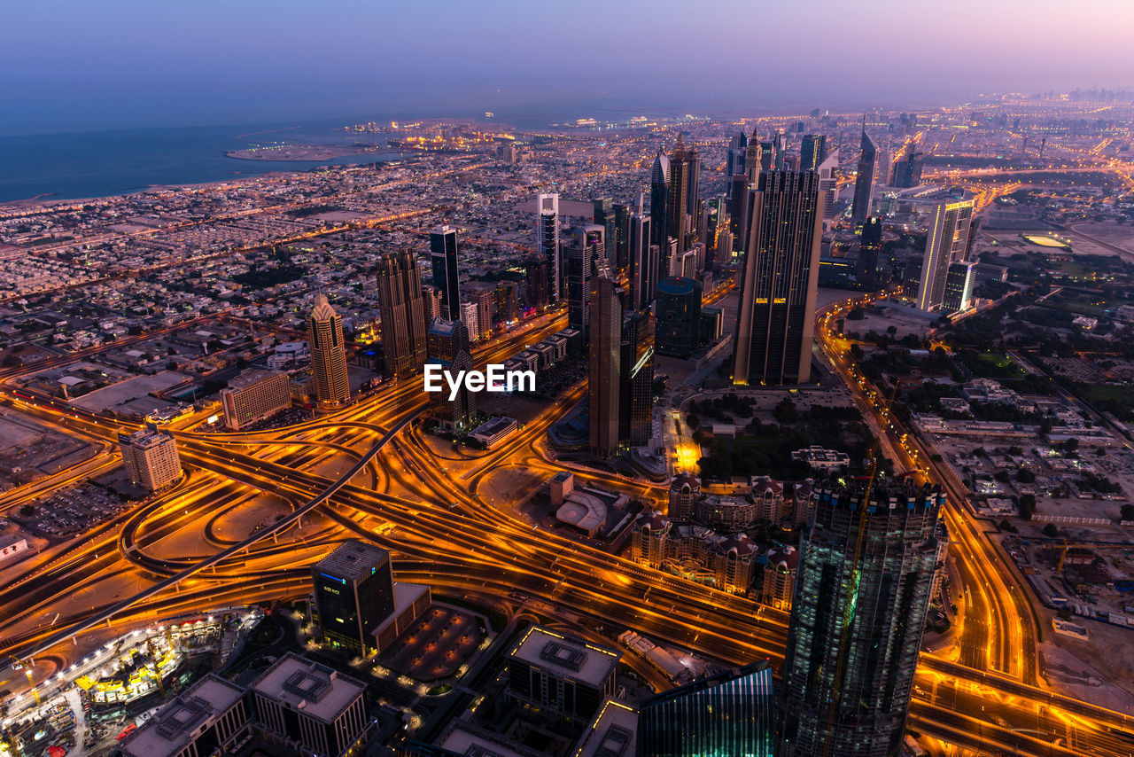 Aerial view of illuminated buildings in city at night