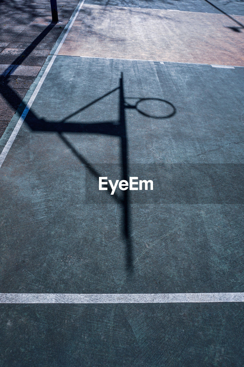 Street basketball hoop shadows on the court