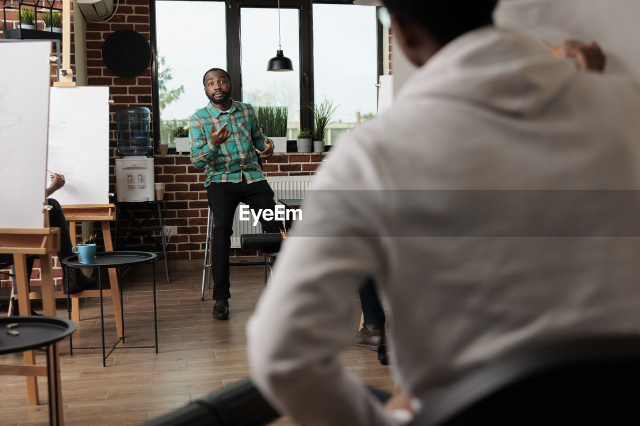 rear view of man standing at restaurant