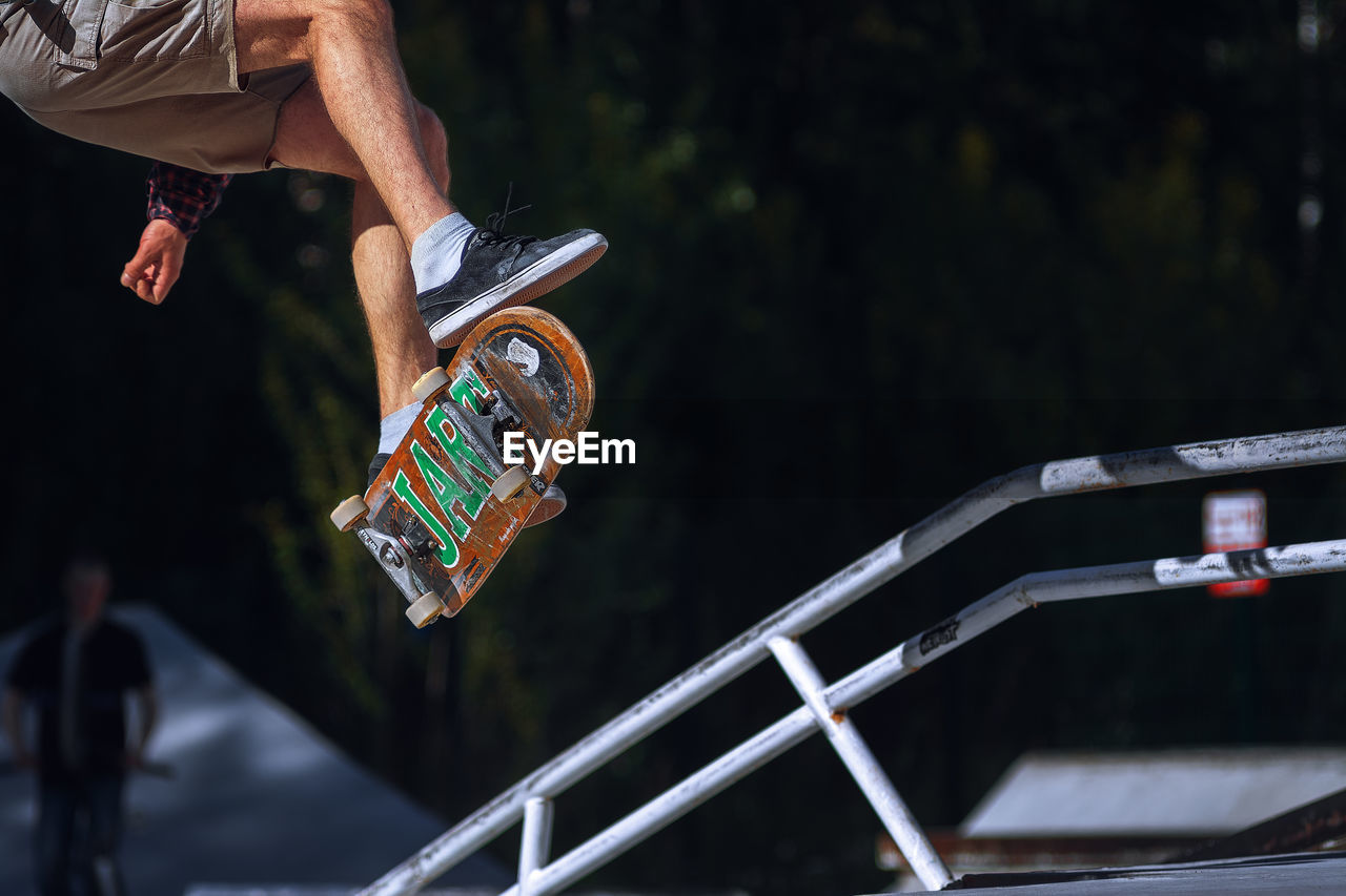 Close-up of man skateboarding in park 