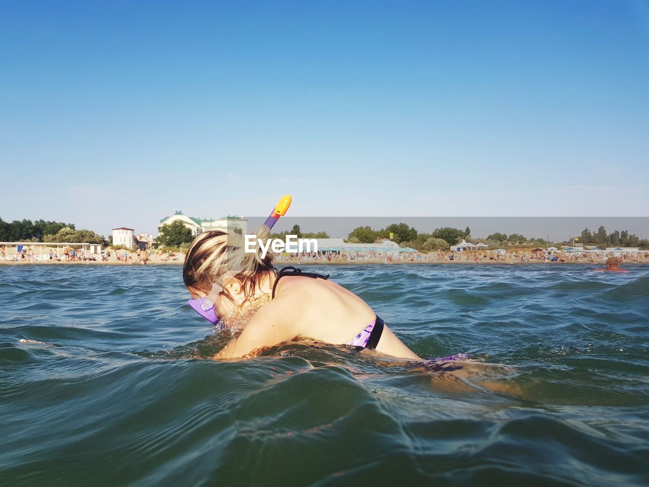 WOMAN IN SEA AGAINST SKY