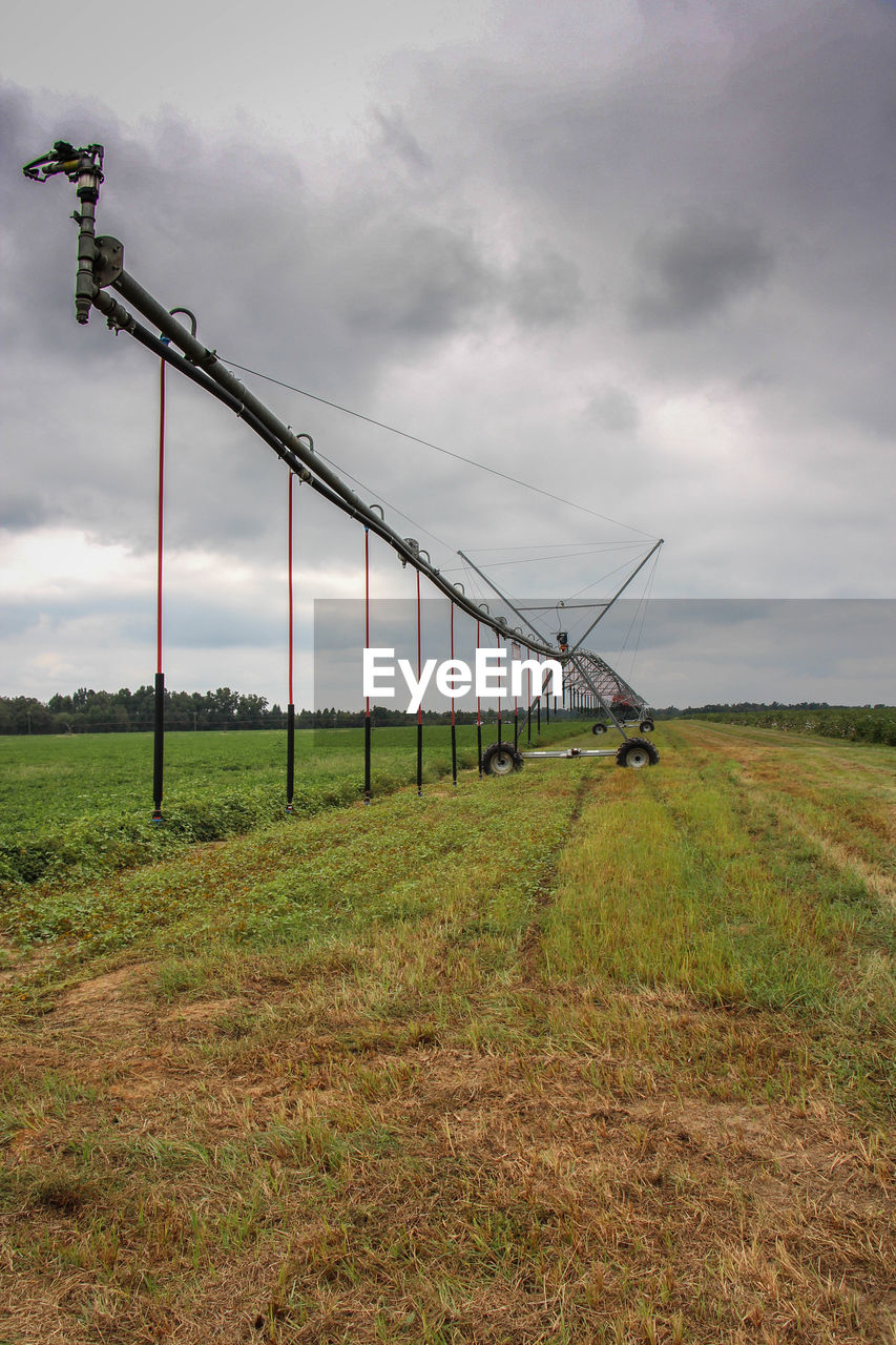 Windmills on field against sky