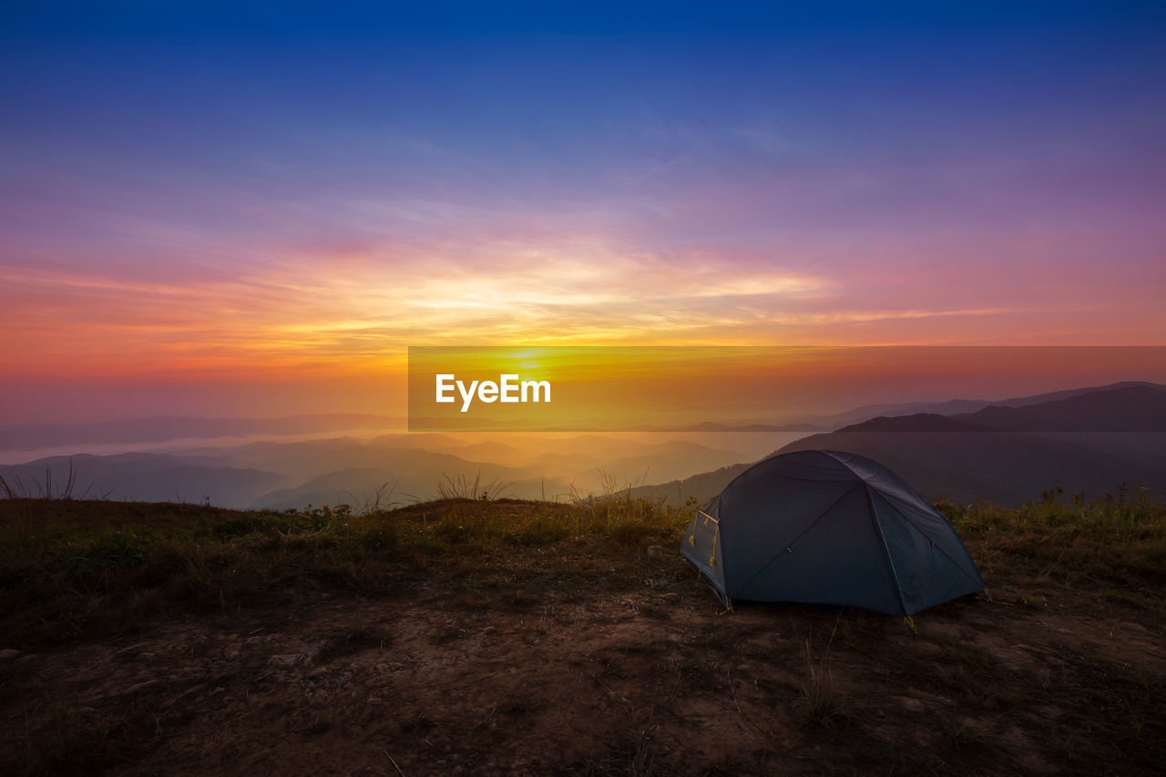 SCENIC VIEW OF SUNSET OVER FIELD