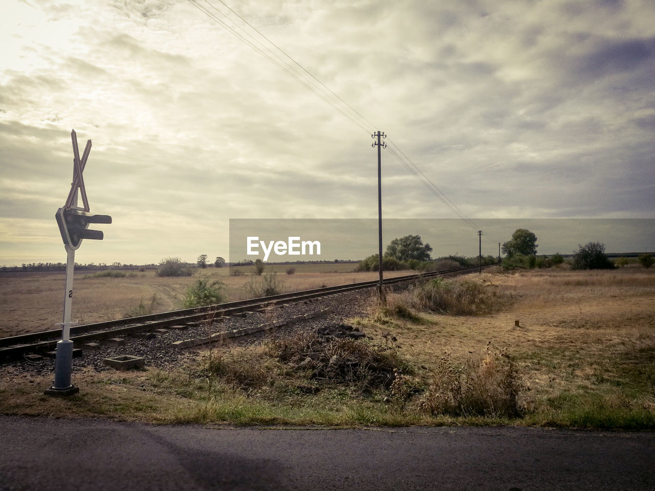 Railway amidst field against sky