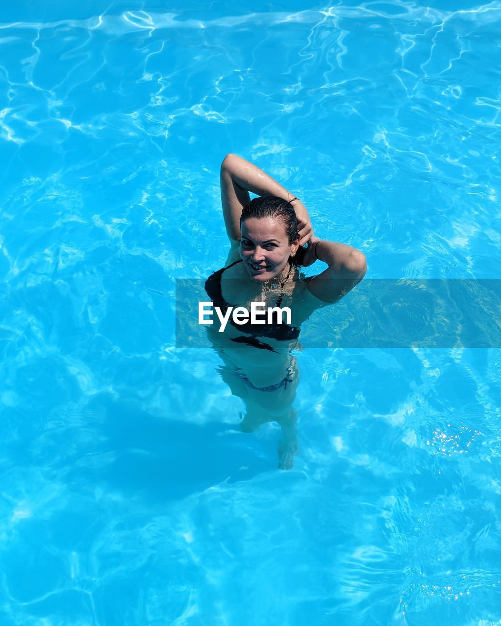 High angle view of woman swimming in pool