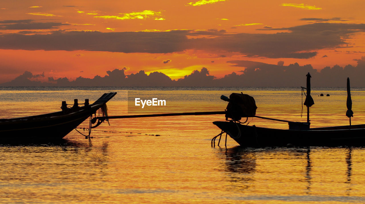 SILHOUETTE BOAT IN SEA AGAINST ORANGE SKY