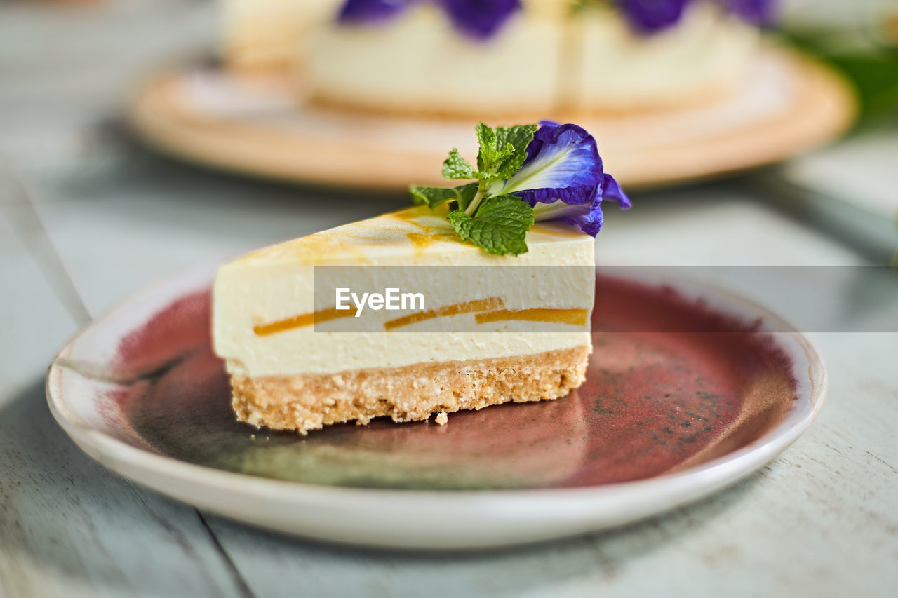 food and drink, food, plate, sweet food, dessert, sweet, cake, freshness, dish, fruit, baked, produce, breakfast, healthy eating, meal, cheesecake, icing, table, no people, slice, sweetness, indoors, temptation, selective focus, close-up, flower, gourmet