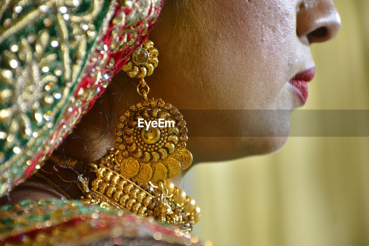 Close-up of woman wearing mask against blurred background