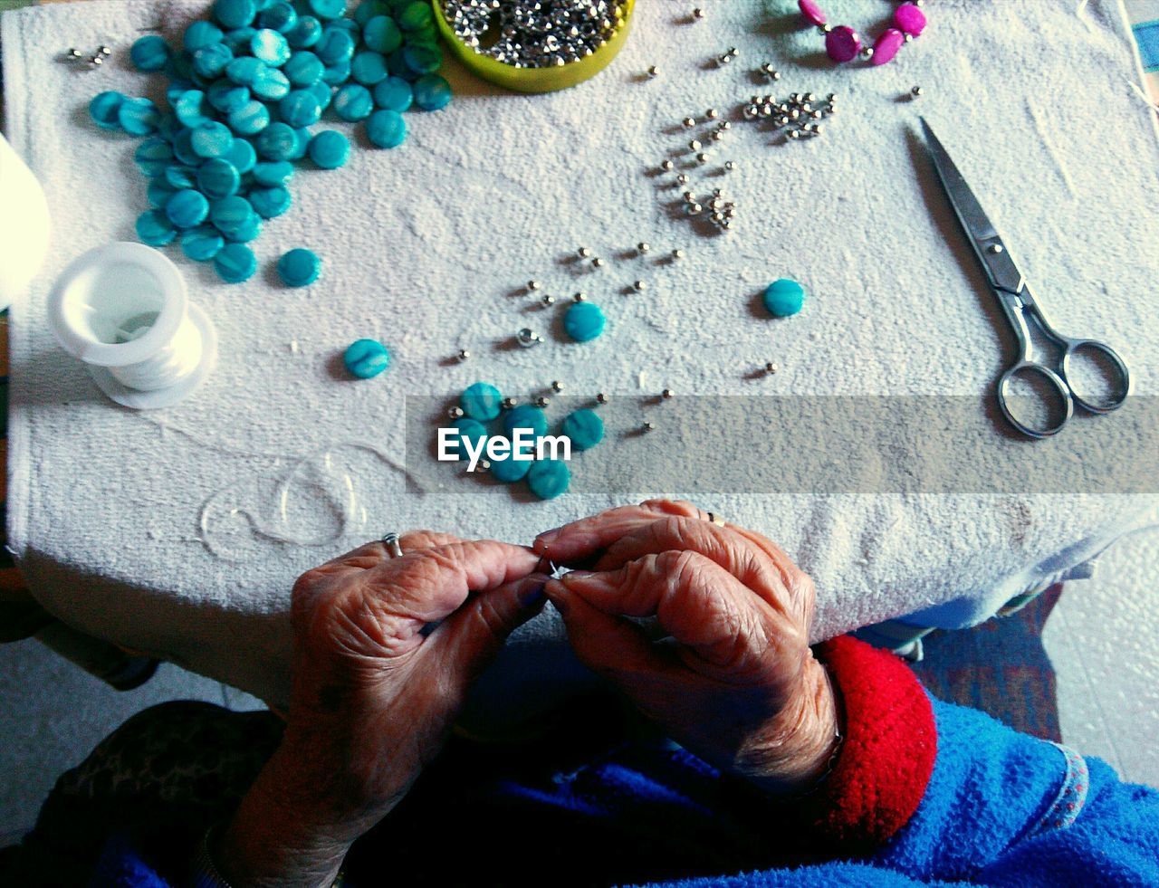 Cropped image of senior woman making jewelry