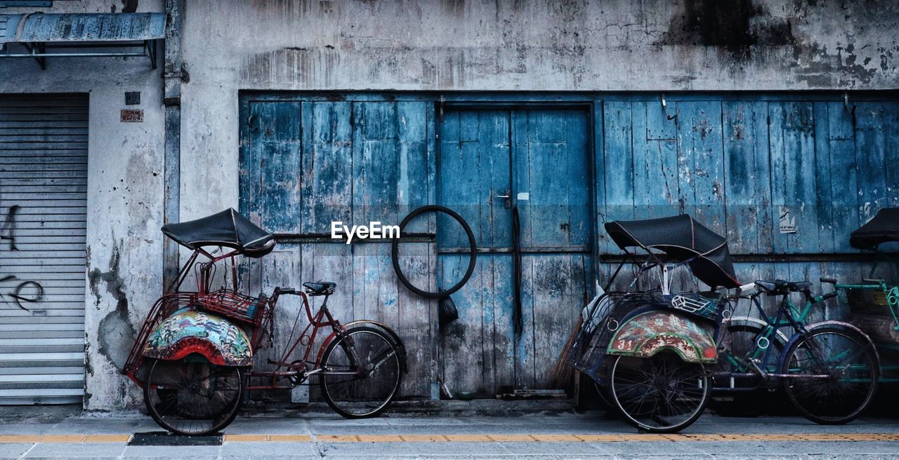 Bicycles parked against wall in old building