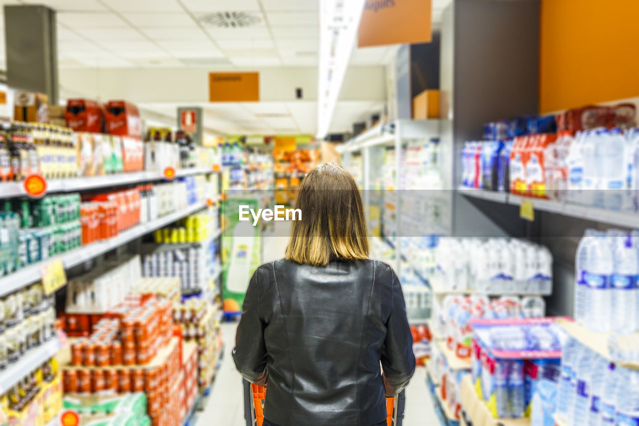 Rear view of woman shopping at supermarket