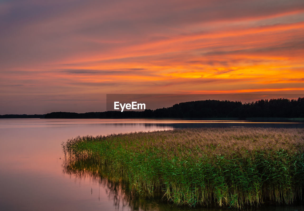 SCENIC VIEW OF LAKE AGAINST ORANGE SUNSET SKY