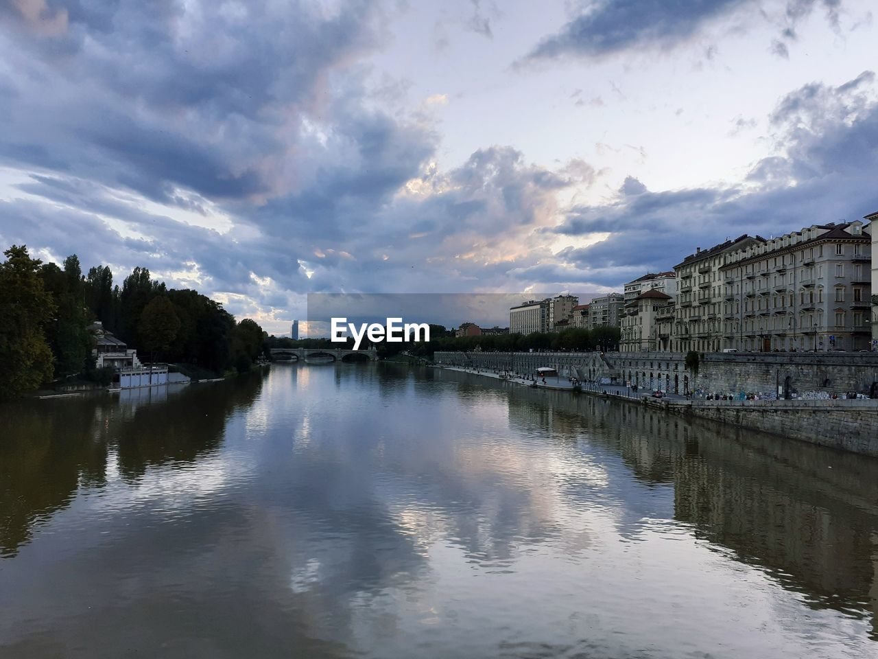 RIVER AMIDST BUILDINGS AGAINST SKY