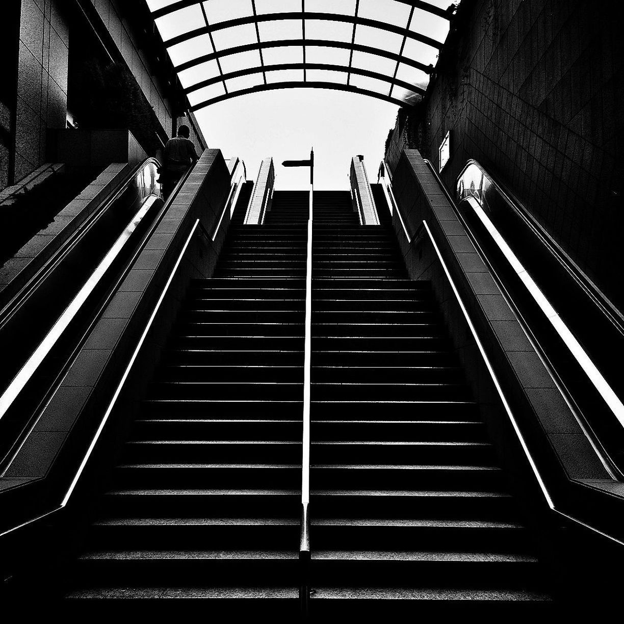 Low-angle view of steps and escalator