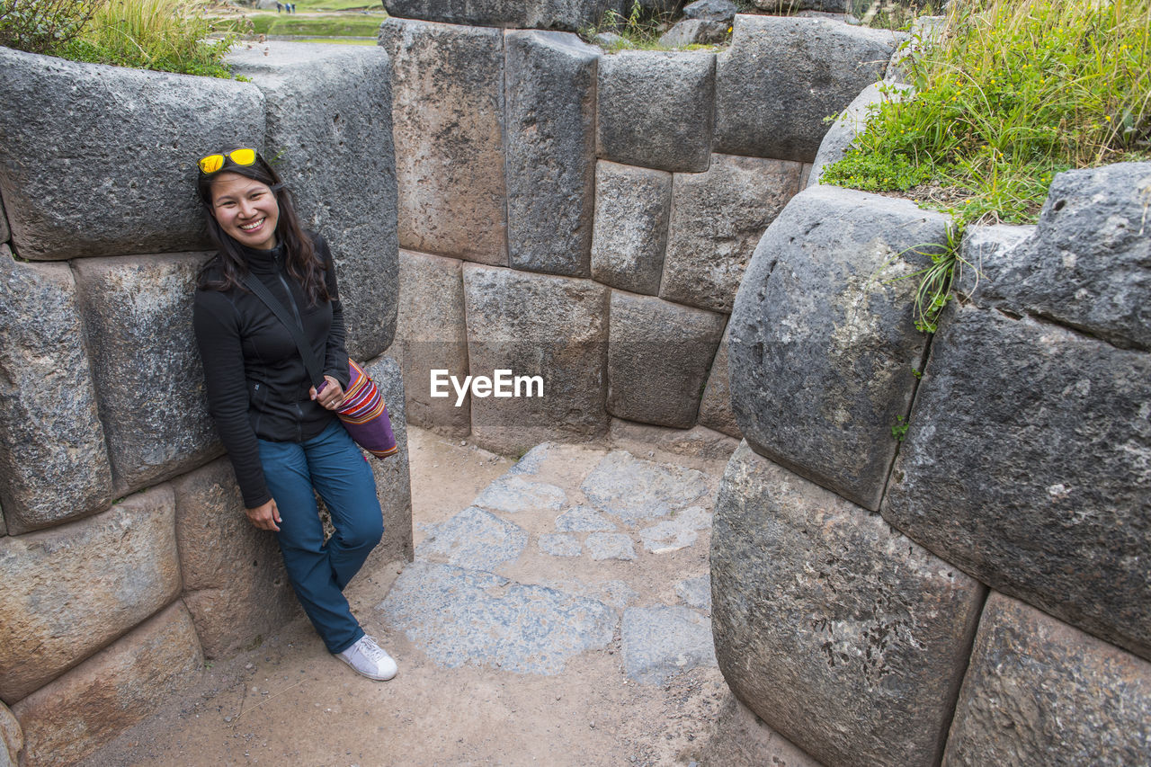 Woman exploring sacsayhuaman, an ancient inca site above cusco / peru