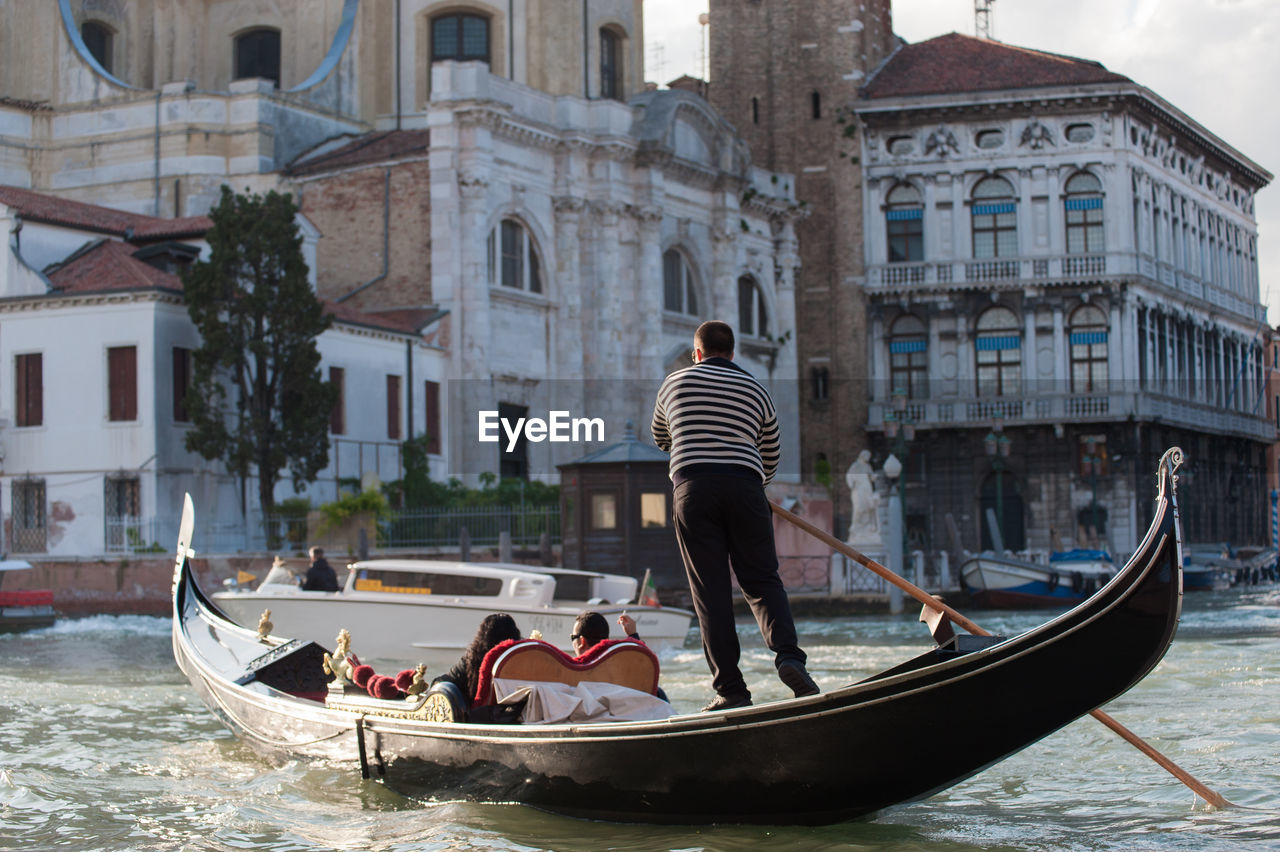 PEOPLE IN BOAT IN CANAL