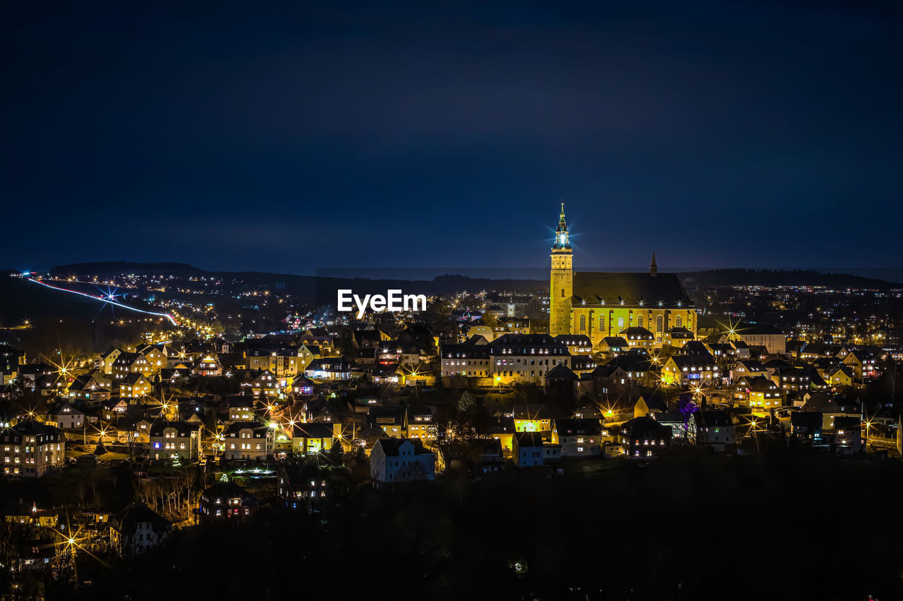 High angle view of city lit up at night on christmastime