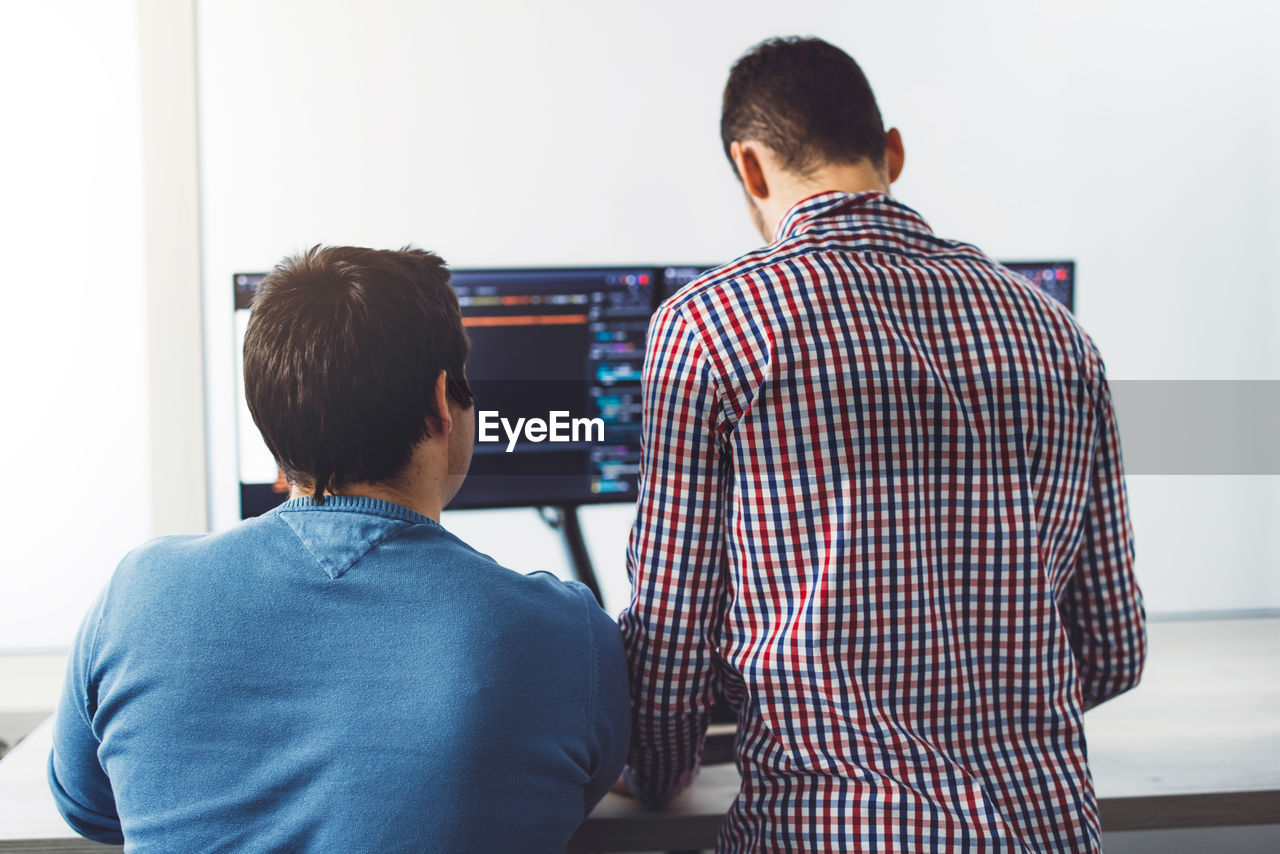 rear view of man standing against wall