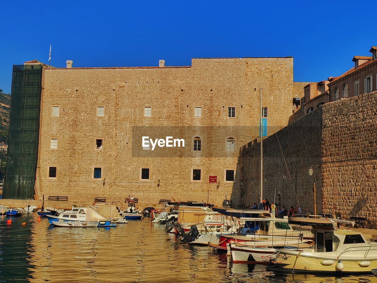 architecture, water, building exterior, nautical vessel, built structure, waterway, transportation, mode of transportation, building, nature, travel, travel destinations, boat, clear sky, sky, city, tourism, moored, town, river, vehicle, day, waterfront, sunny, outdoors, history, watercraft, ship, blue, sunlight, the past, no people