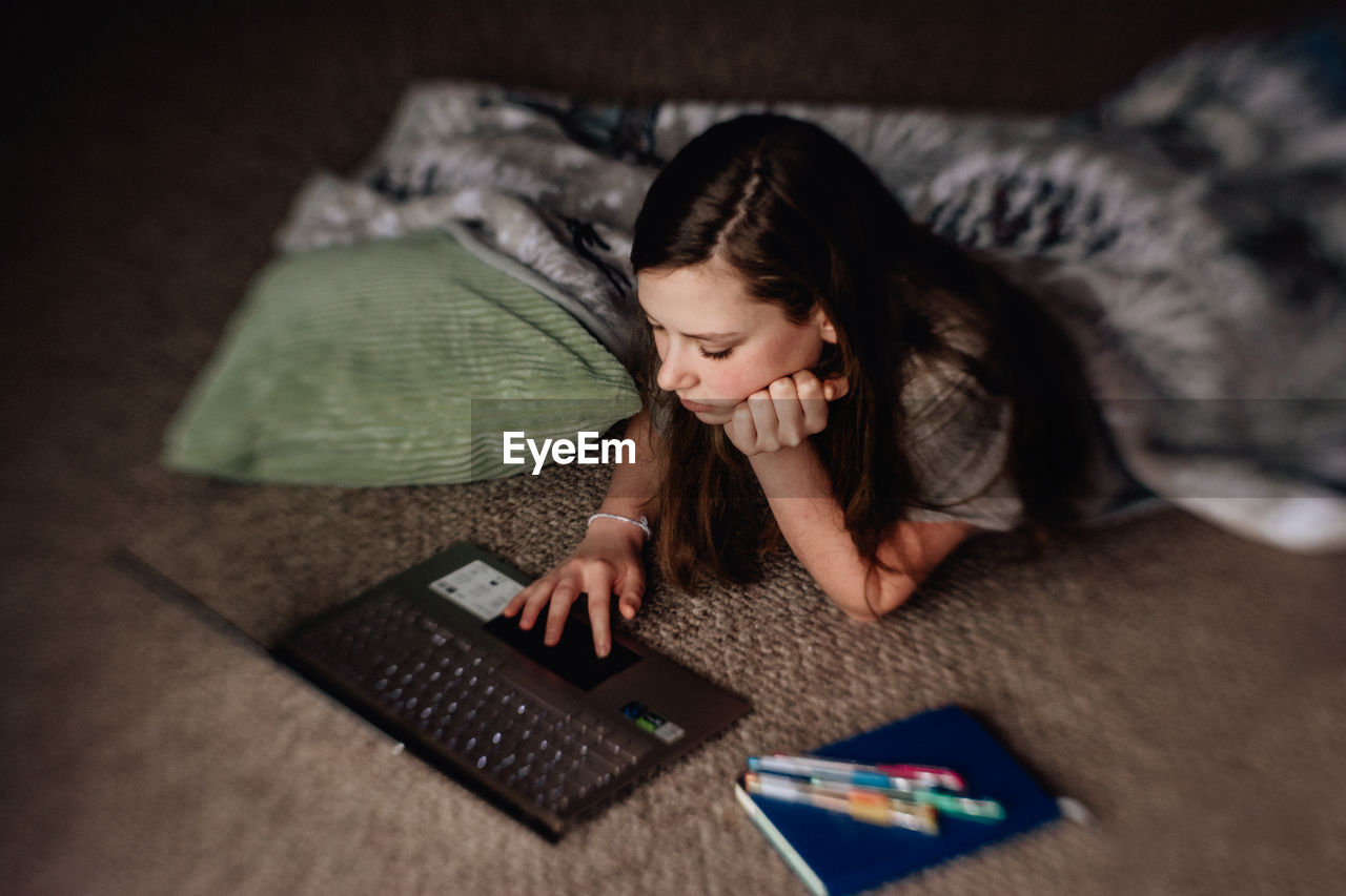 Young woman using laptop while at home