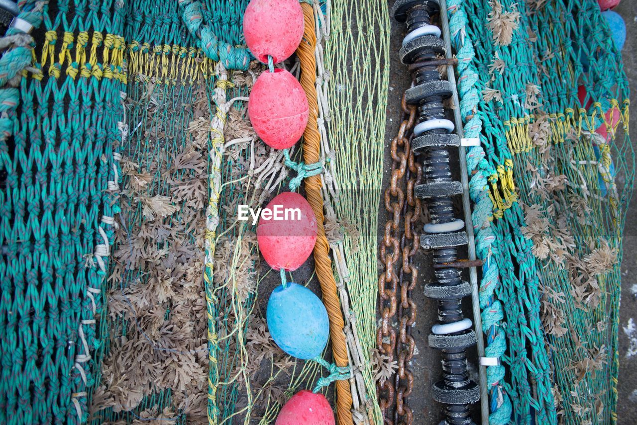 Directly above shot of buoy and fishing nets on field