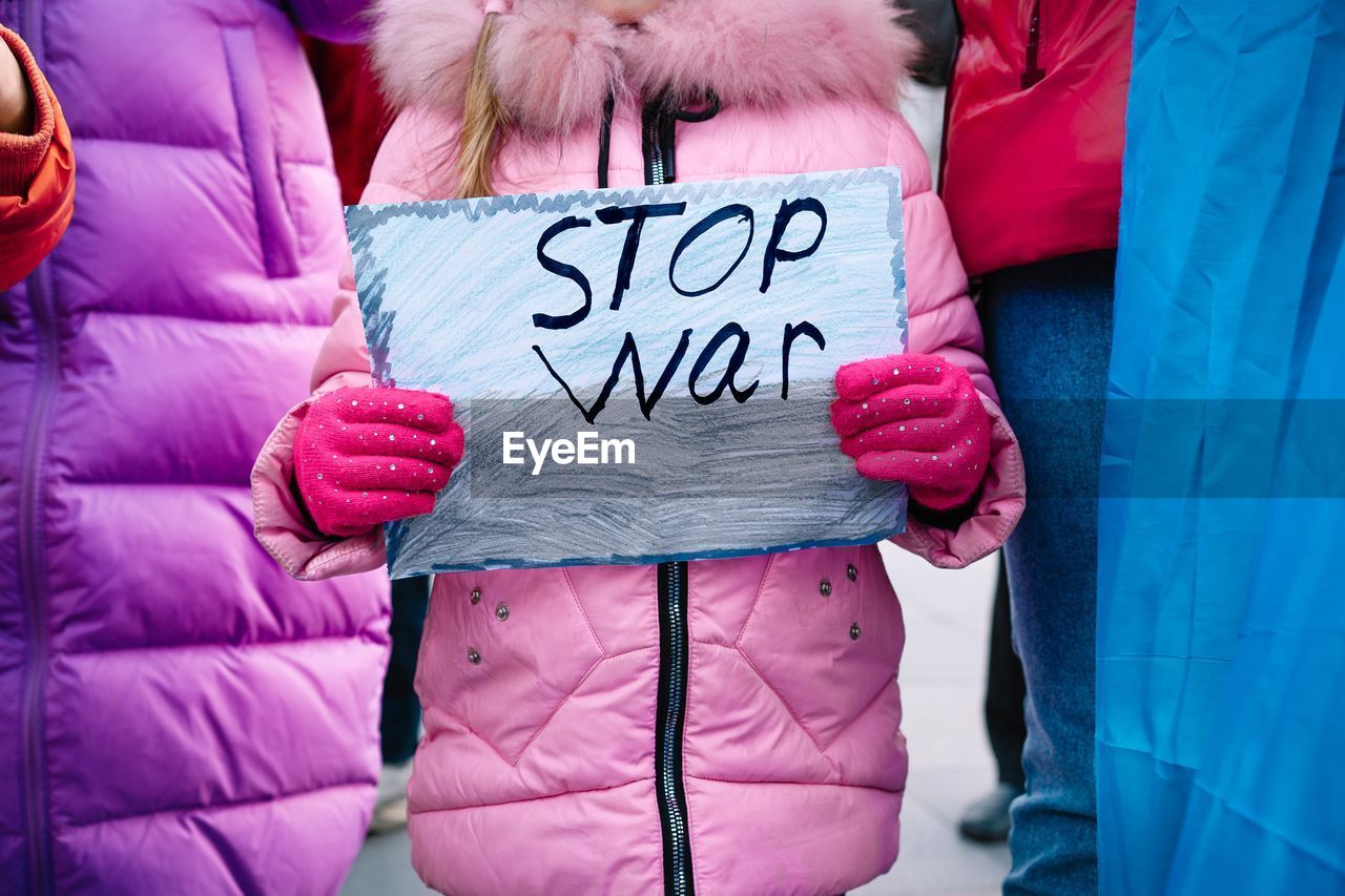 Child protesting against war. stop war banner at rally