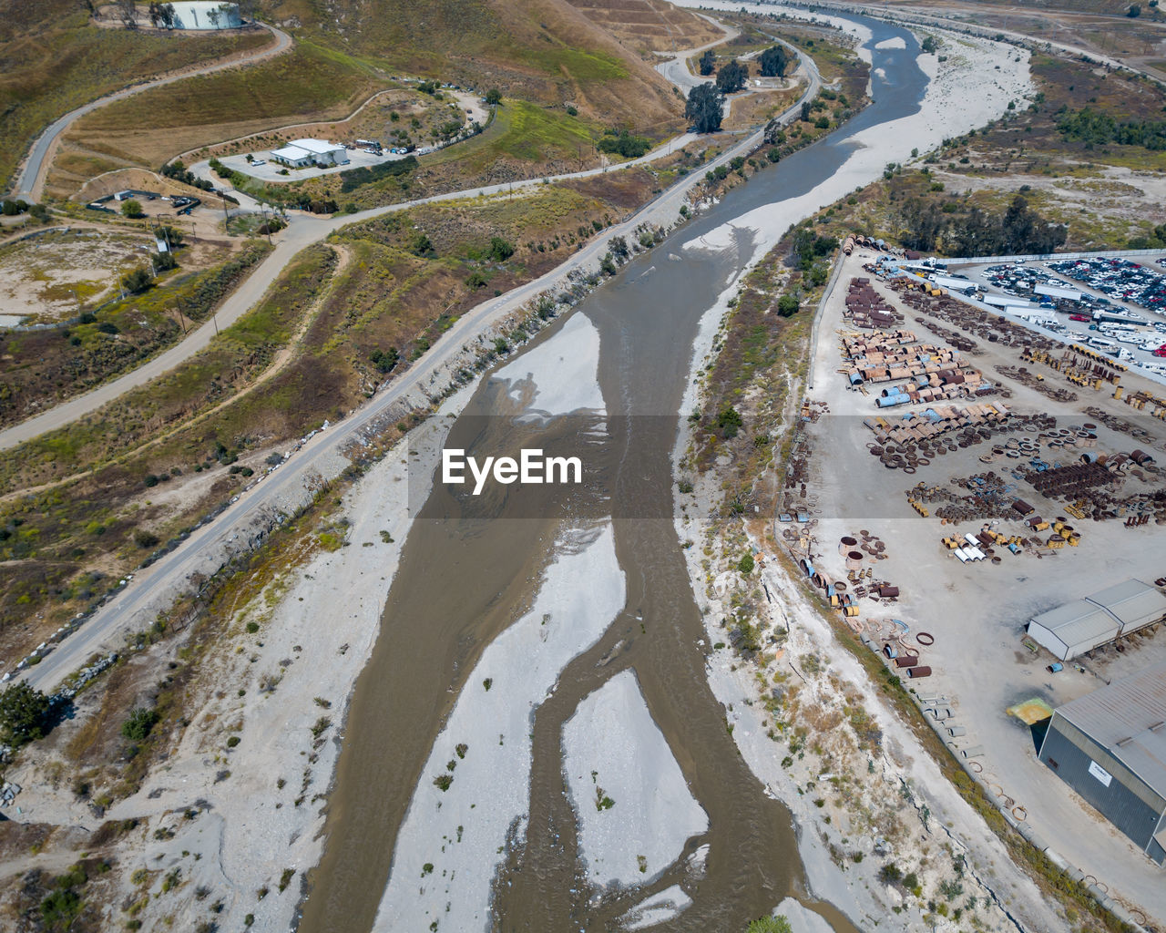 HIGH ANGLE VIEW OF ROAD AMIDST LAND