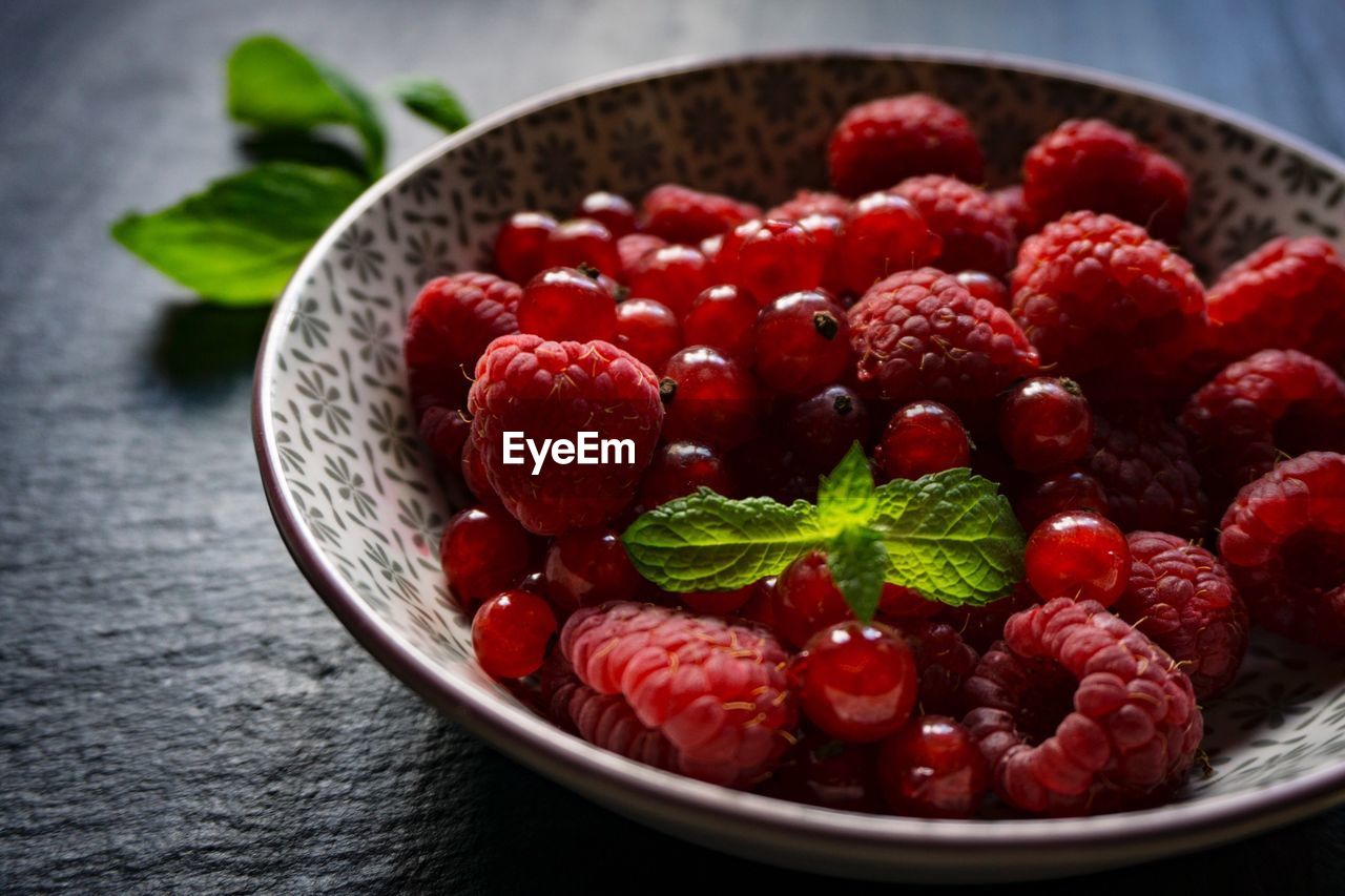 Close-up of raspberries with cherries in bowl