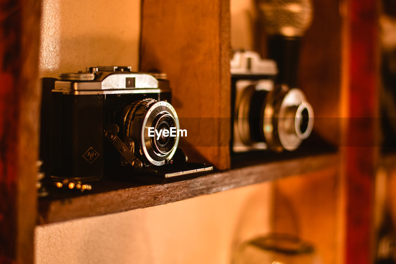 Close-up of camera on shelf