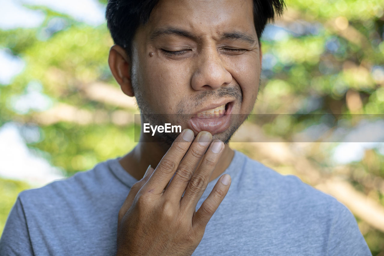 Close-up of man making face