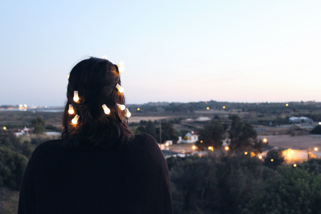 REAR VIEW OF WOMAN IN CITY AGAINST SKY