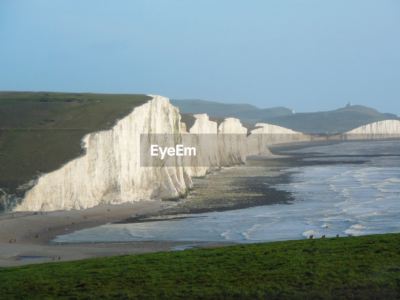 Scenic view of beach against clear blue sky