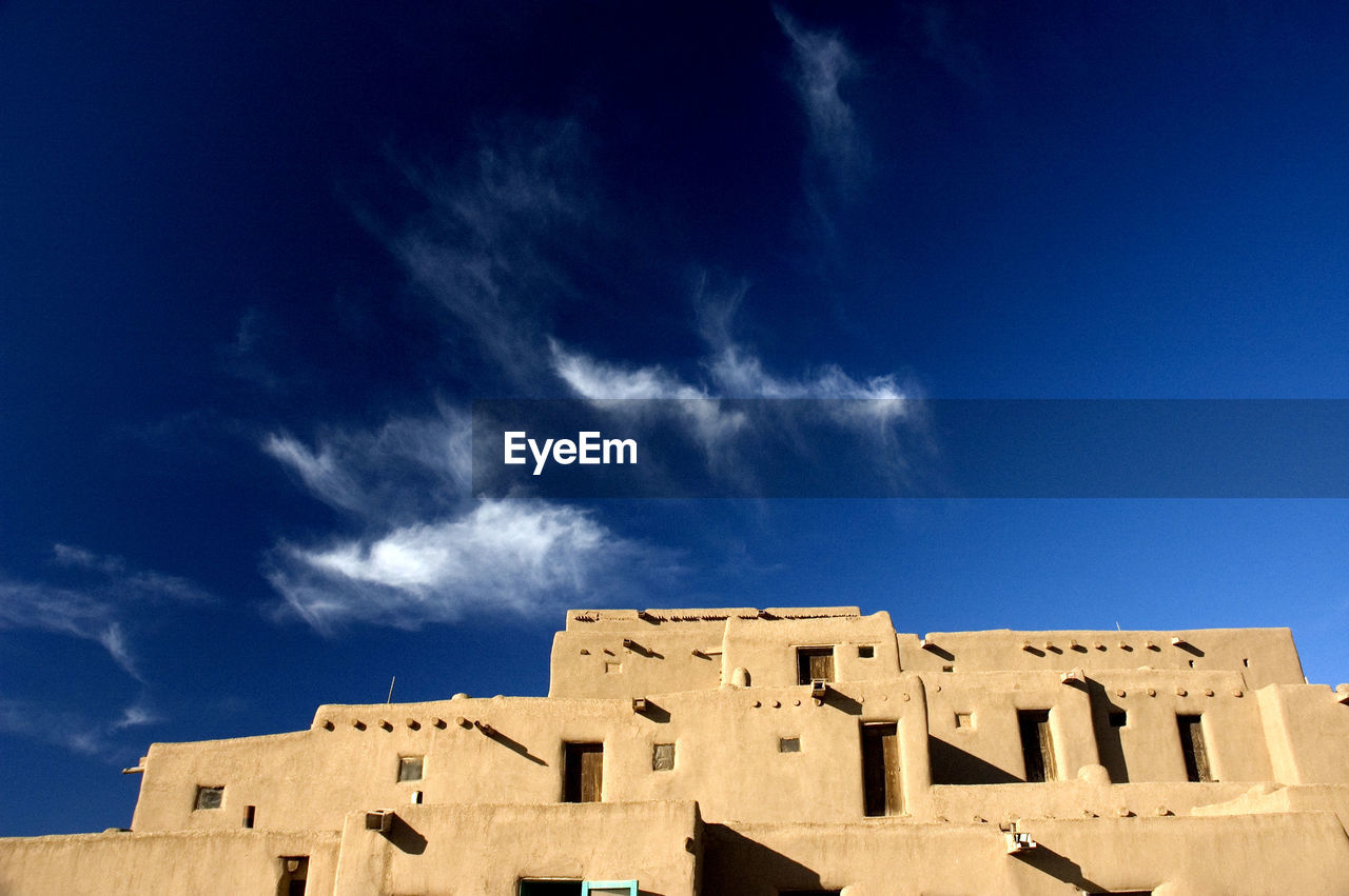 Low angle view of historical building against blue sky