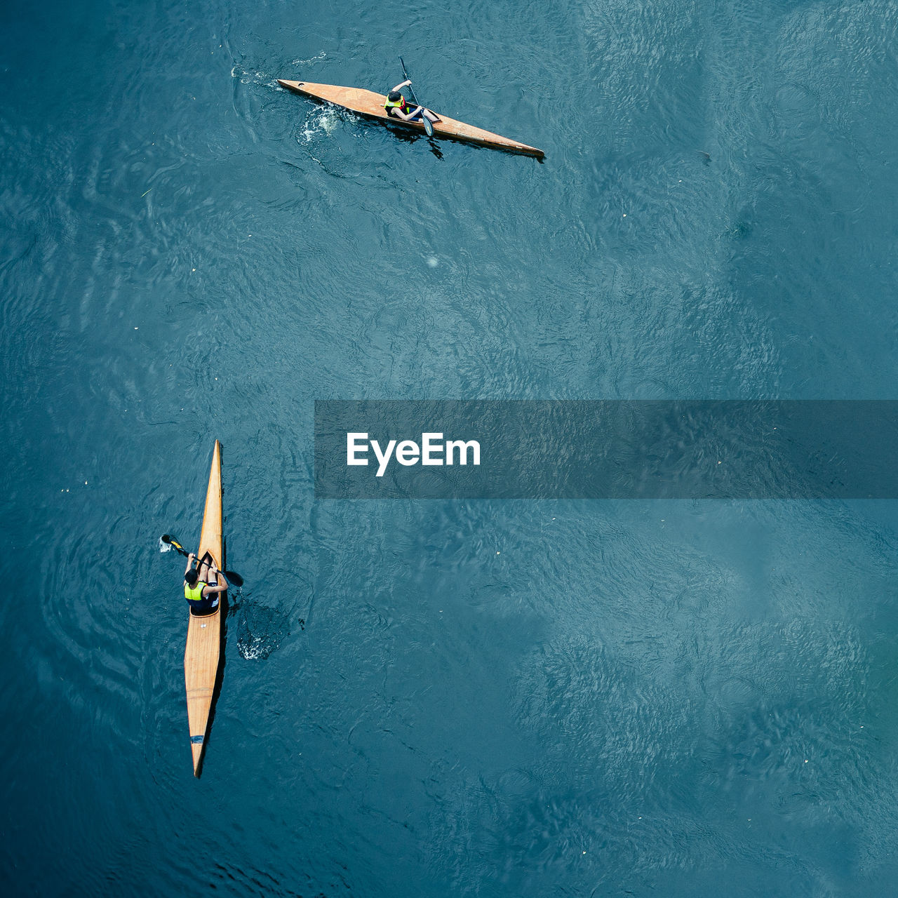 High angle view of people canoeing in sea