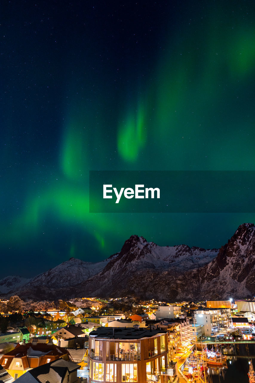 ILLUMINATED BUILDINGS AGAINST SKY AT NIGHT