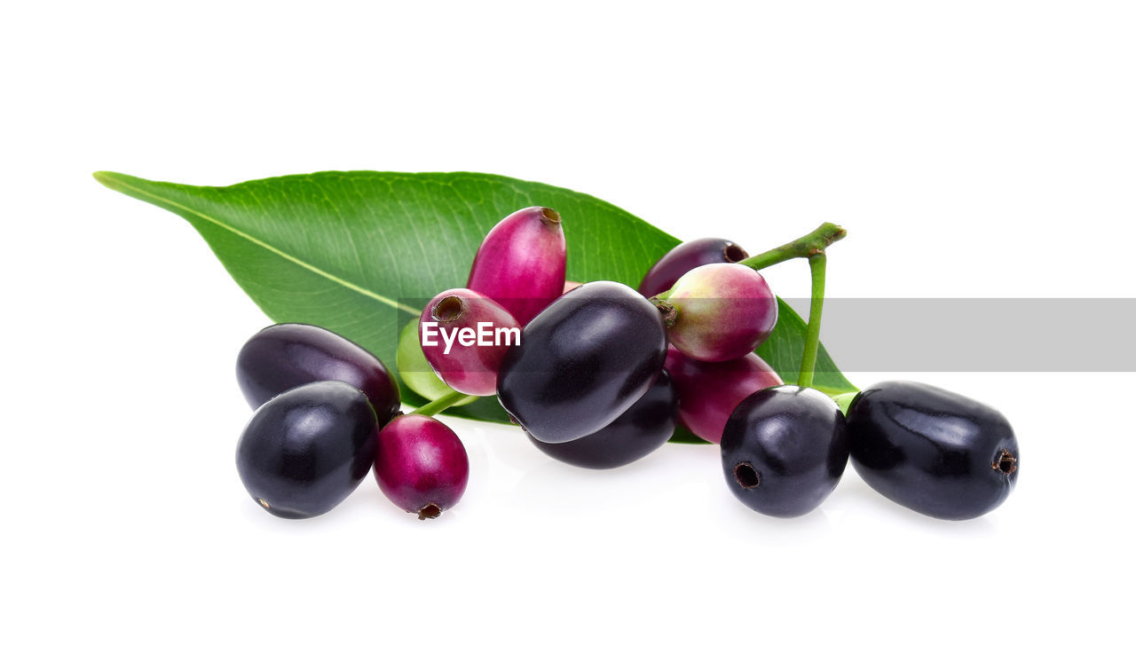 CLOSE-UP OF CHERRIES OVER WHITE BACKGROUND