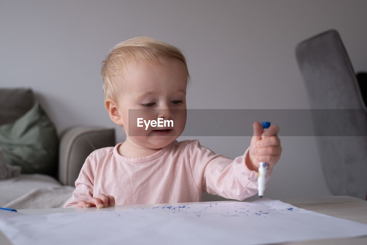 portrait of cute boy drawing on table