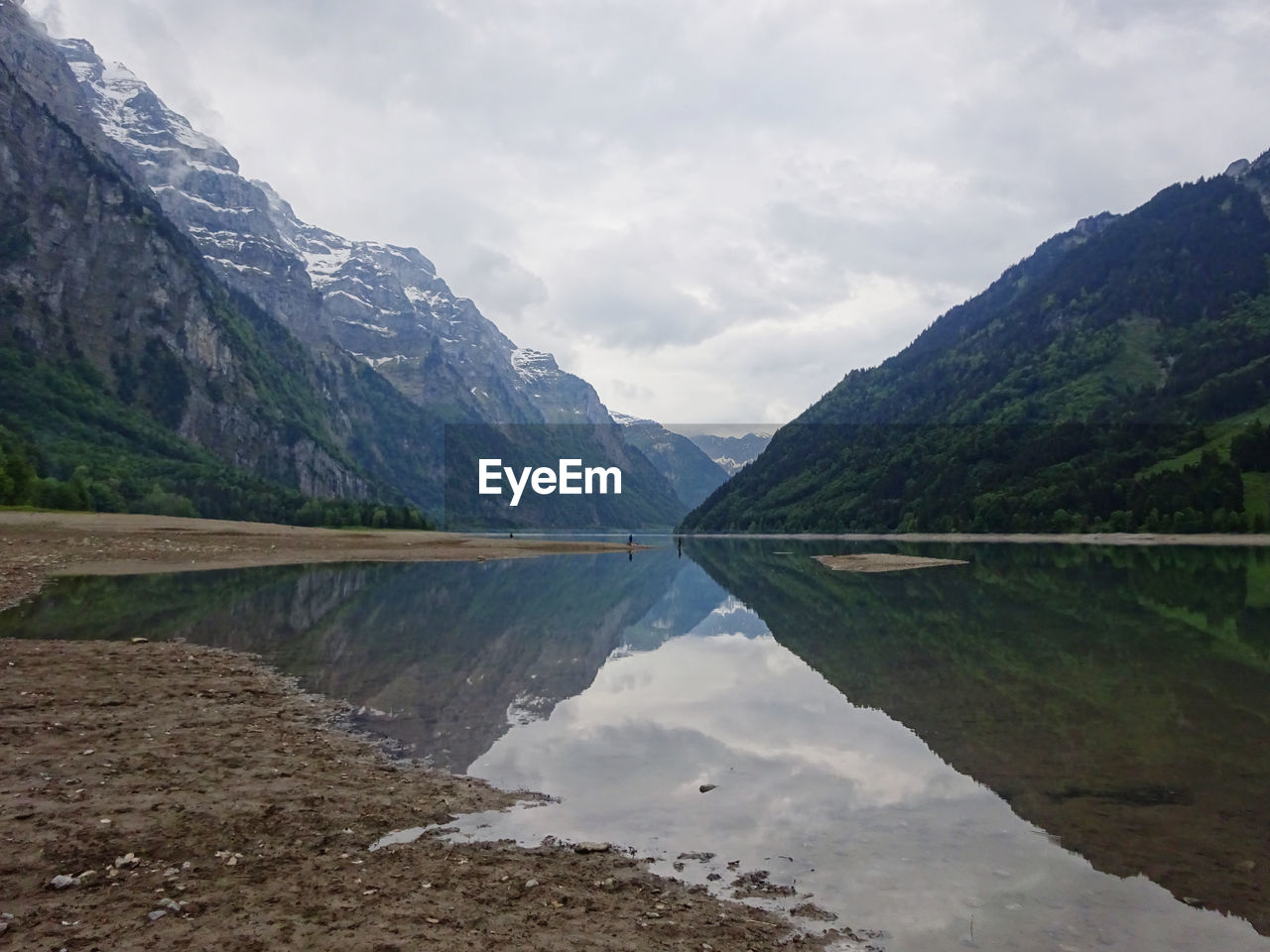 mountain, water, scenics - nature, environment, beauty in nature, landscape, lake, mountain range, reflection, nature, sky, cloud, land, highland, tranquility, travel destinations, tranquil scene, forest, travel, no people, reservoir, valley, tree, tourism, plant, glacial landform, non-urban scene, cold temperature, snow, outdoors, activity, mountain peak, idyllic, pine woodland, day, overcast, vacation, pine tree, trip, pinaceae, holiday, coniferous tree, rock, leisure activity, mountain pass, wilderness