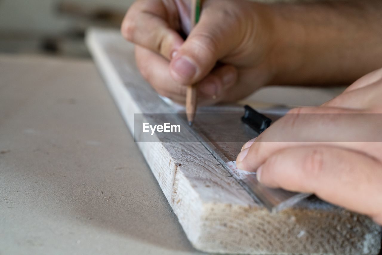 Cropped hands of man working on table