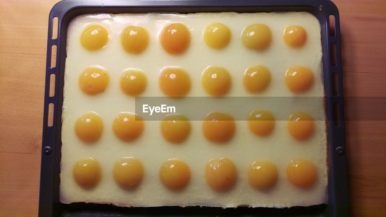 High angle view of fried egg dessert in serving tray on table