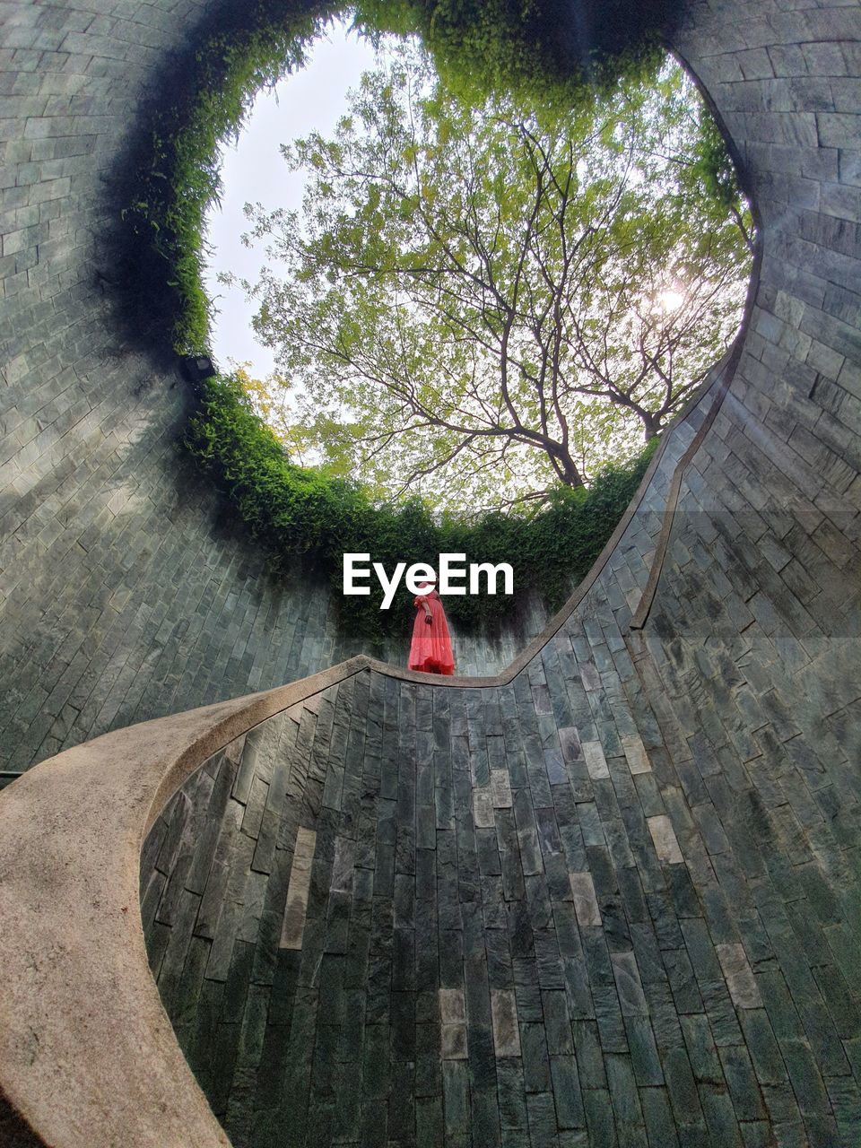 Woman at a spiral staircase