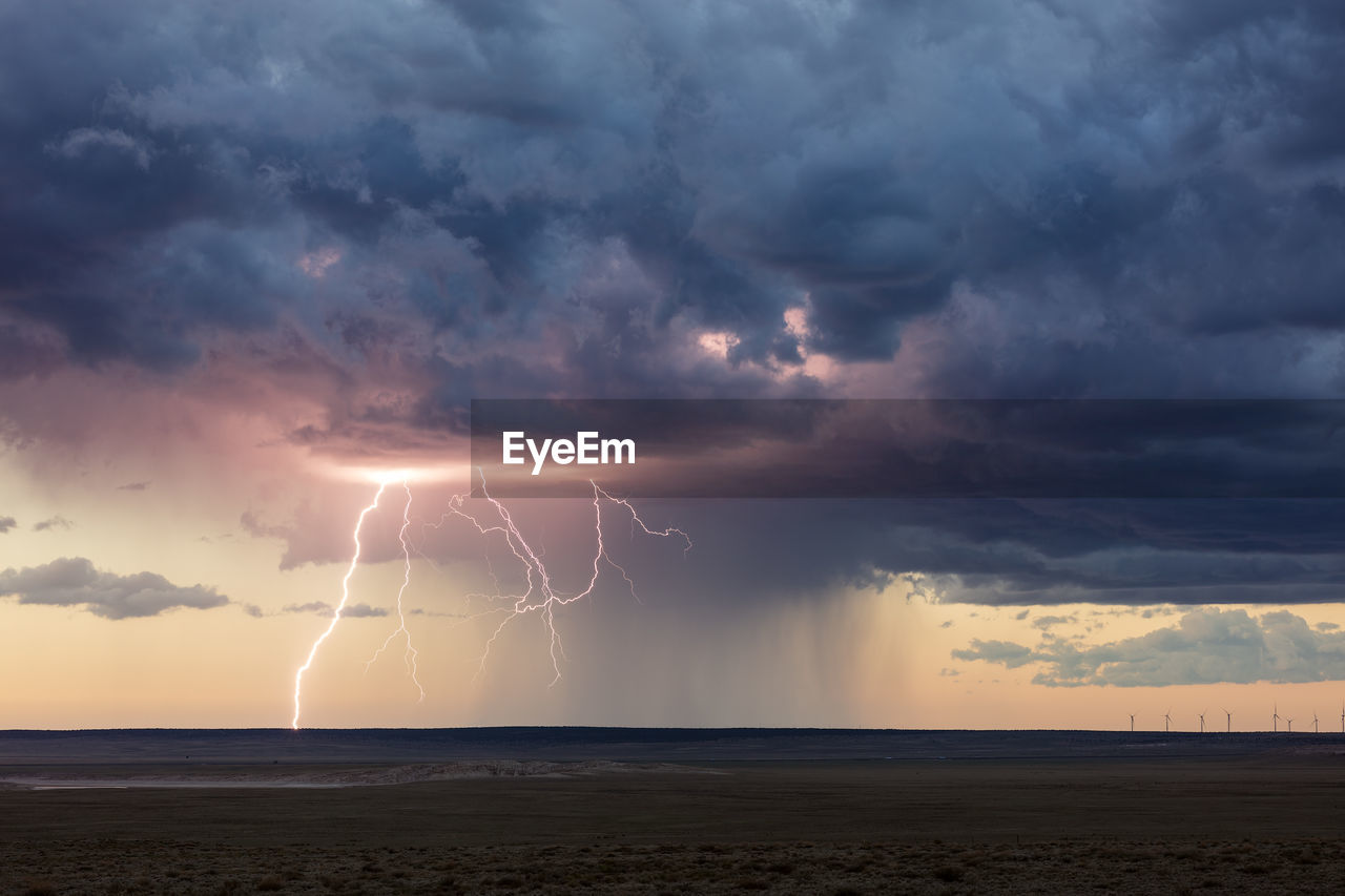 Lightning bolt strike from a thunderstorm at sunset near vaughn, new mexico