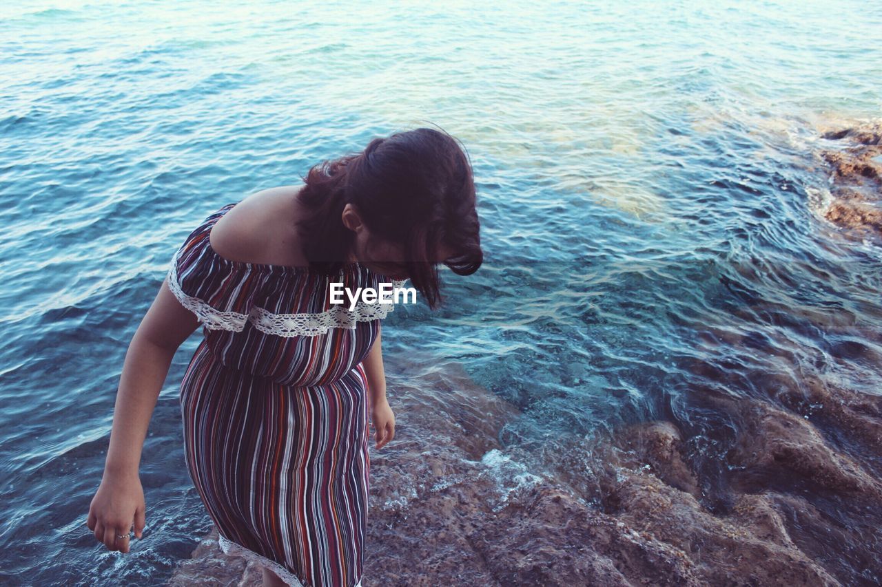 WOMAN IN FRONT OF SEA WATER