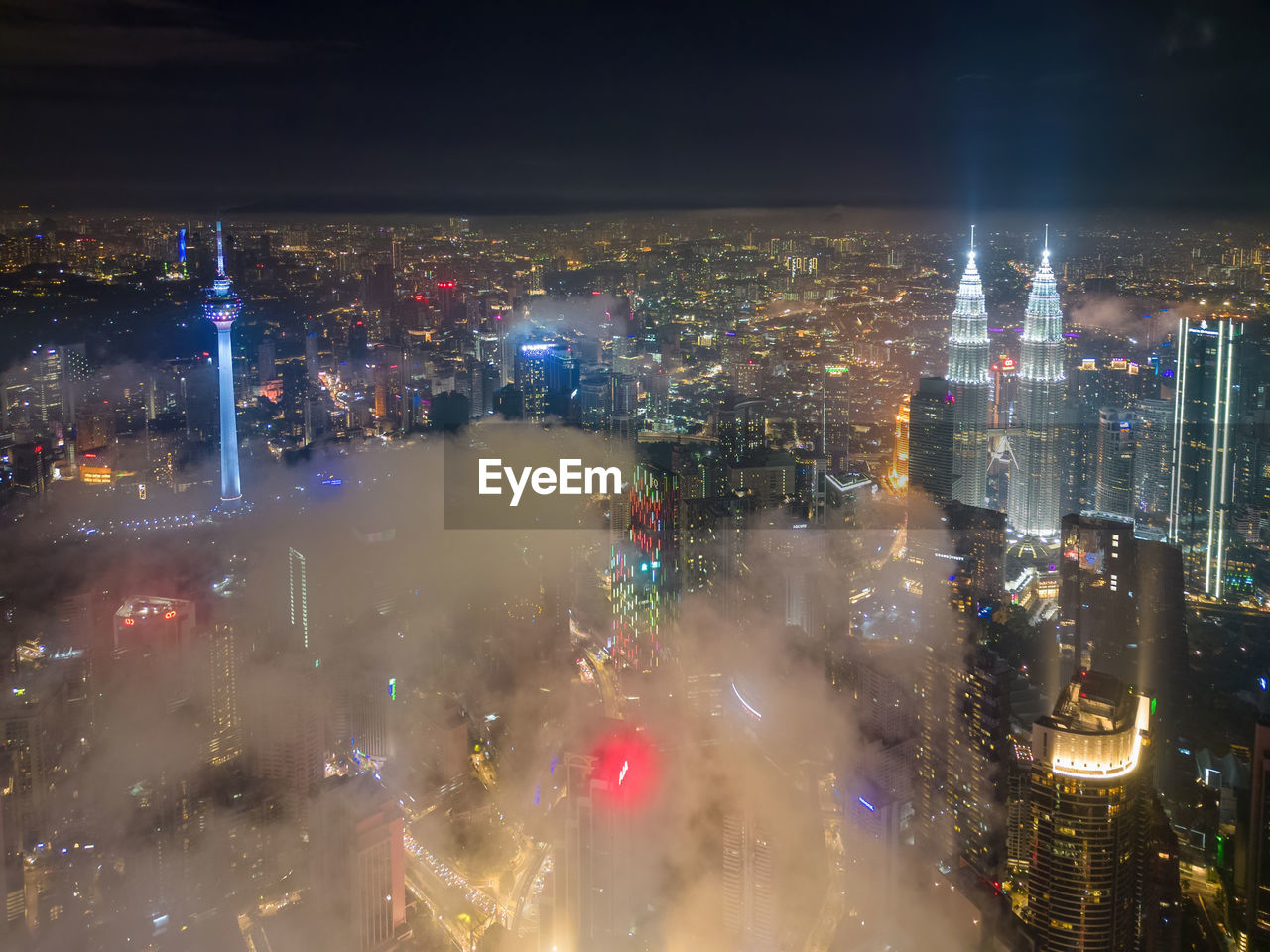 high angle view of illuminated cityscape against sky at night