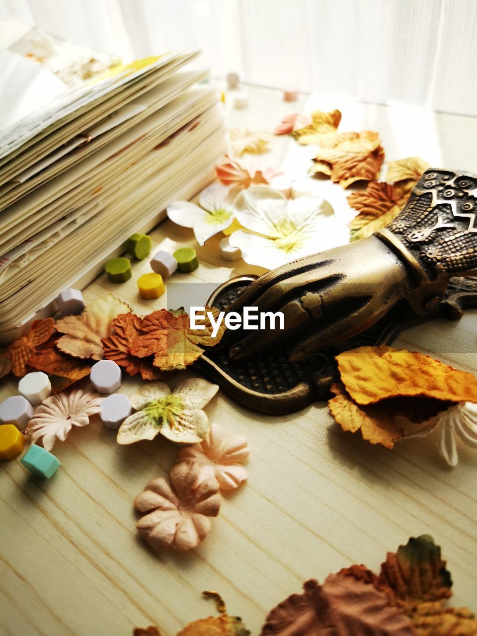 Portrait of a messy table filled with tiny flowers and leafs for scrapbook material